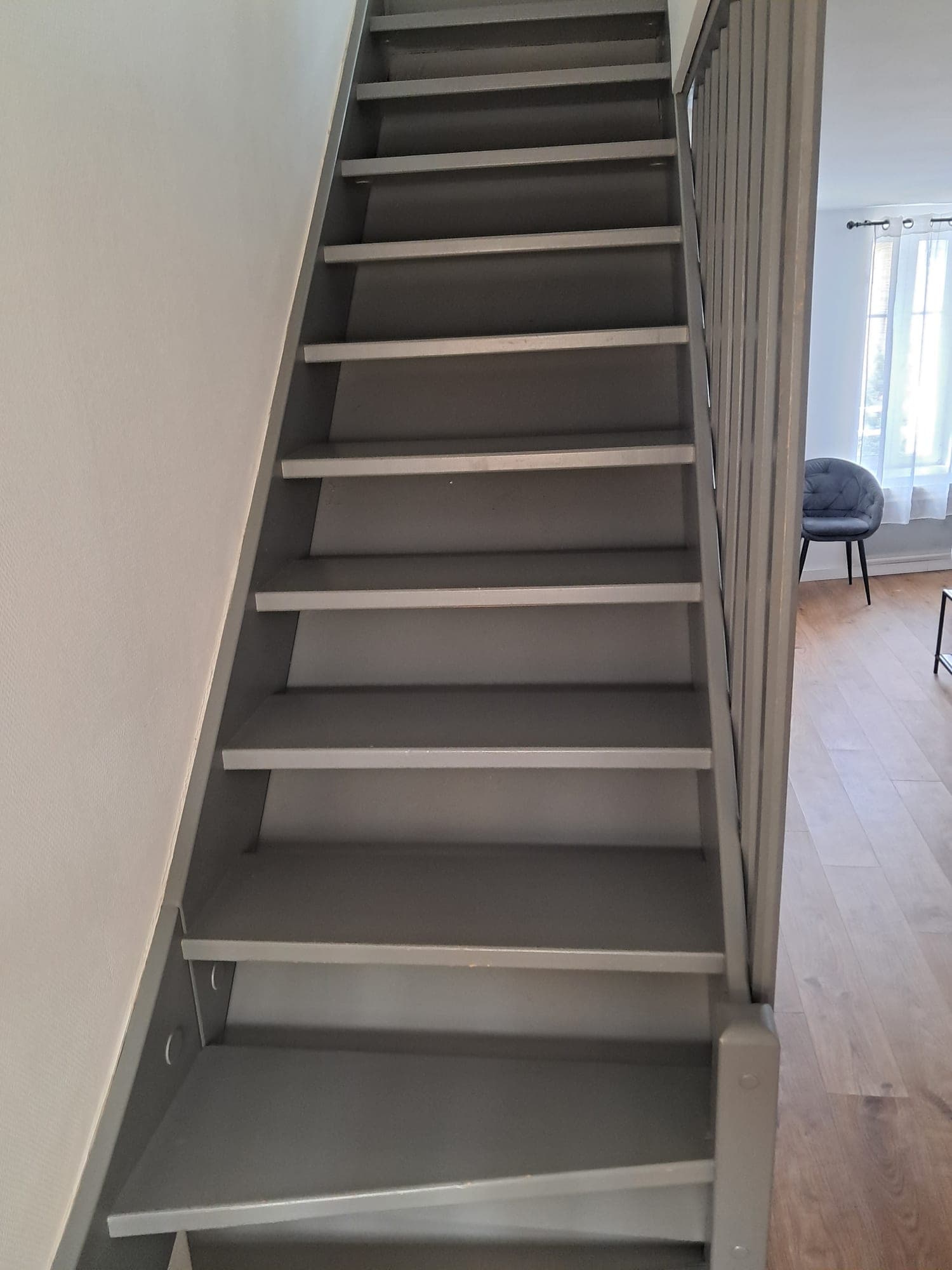Grey-painted wooden staircase, dusted step by step